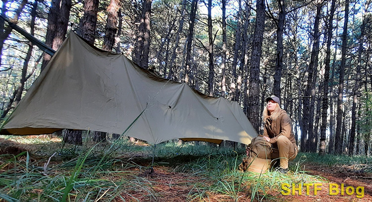 woman setting up Napsack hammock with tarp