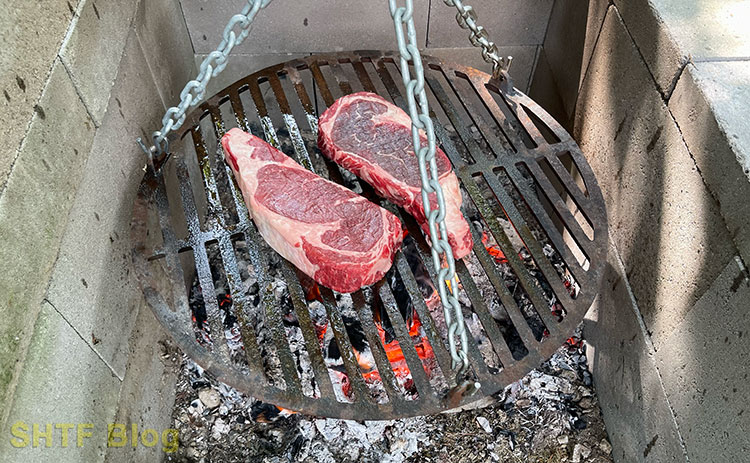 heavy cooking grate with steaks