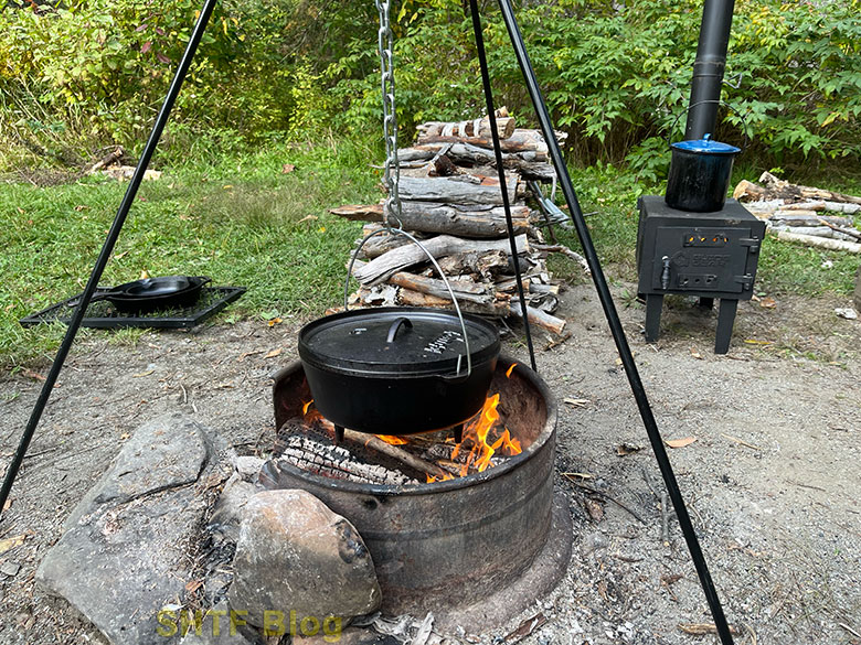 Dutch oven cooking noodles over fire